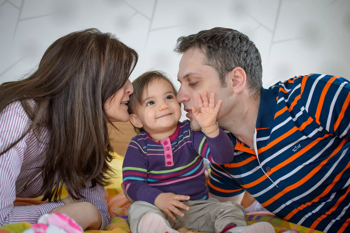 Parents playing with their child