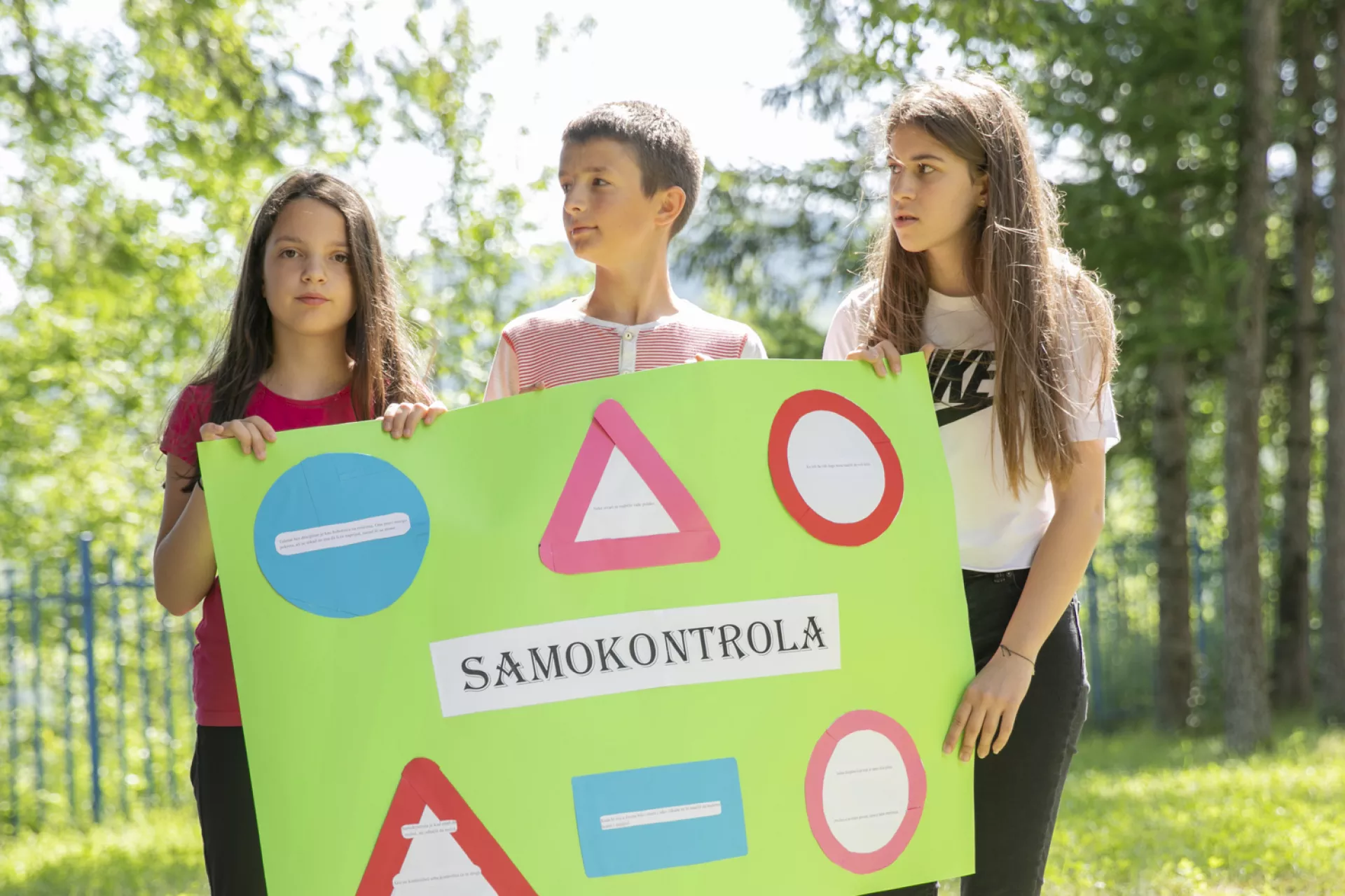 Children holding a poster with social and emotional skills