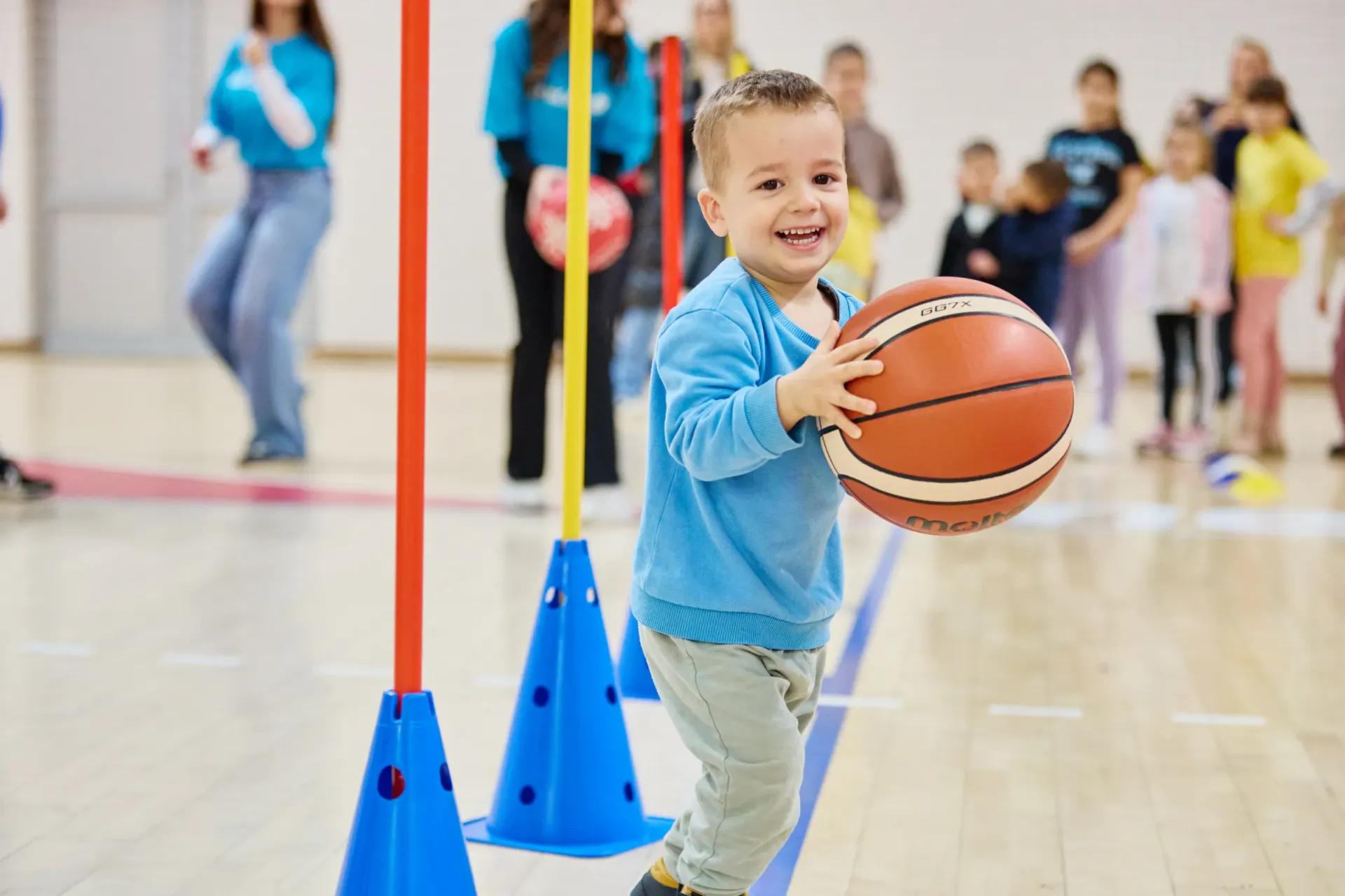 A boy with a ball at a basketball court