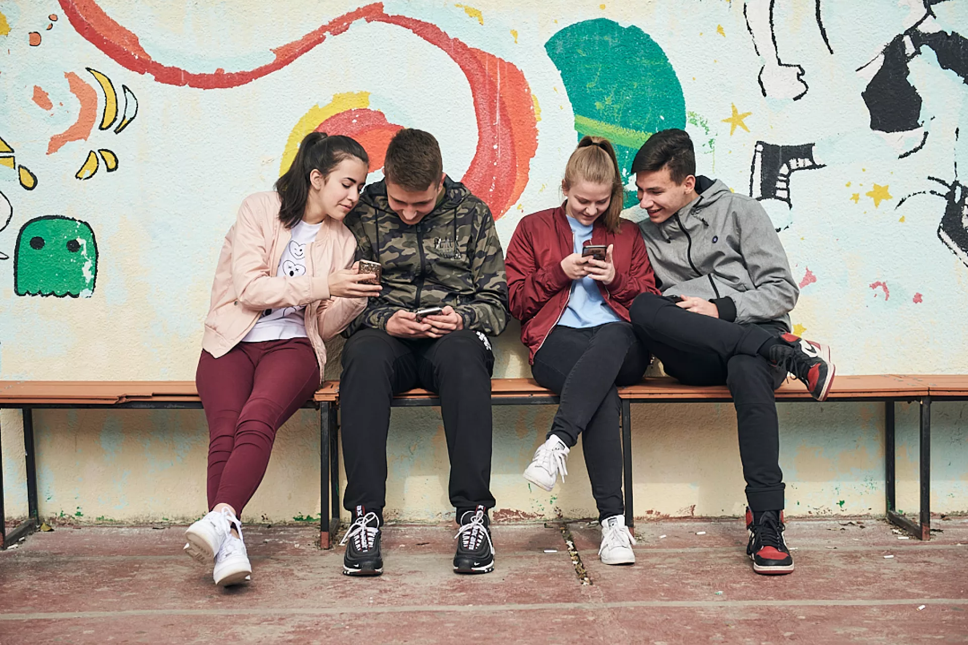 young people watching their mobile phones