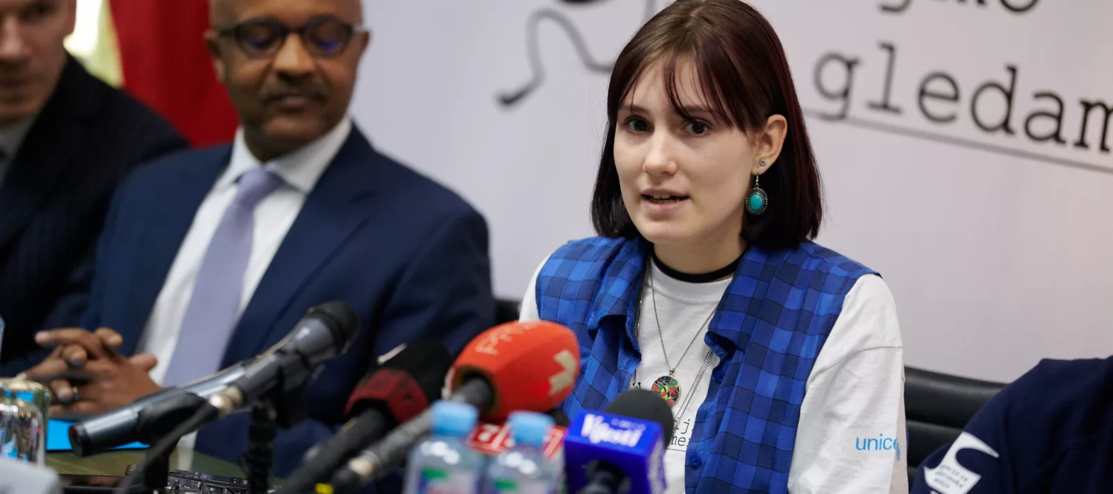 A media literacy campaign young reporter speaking at a press conference