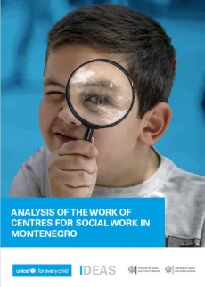 A boy looking at the camera through the magnifying glass