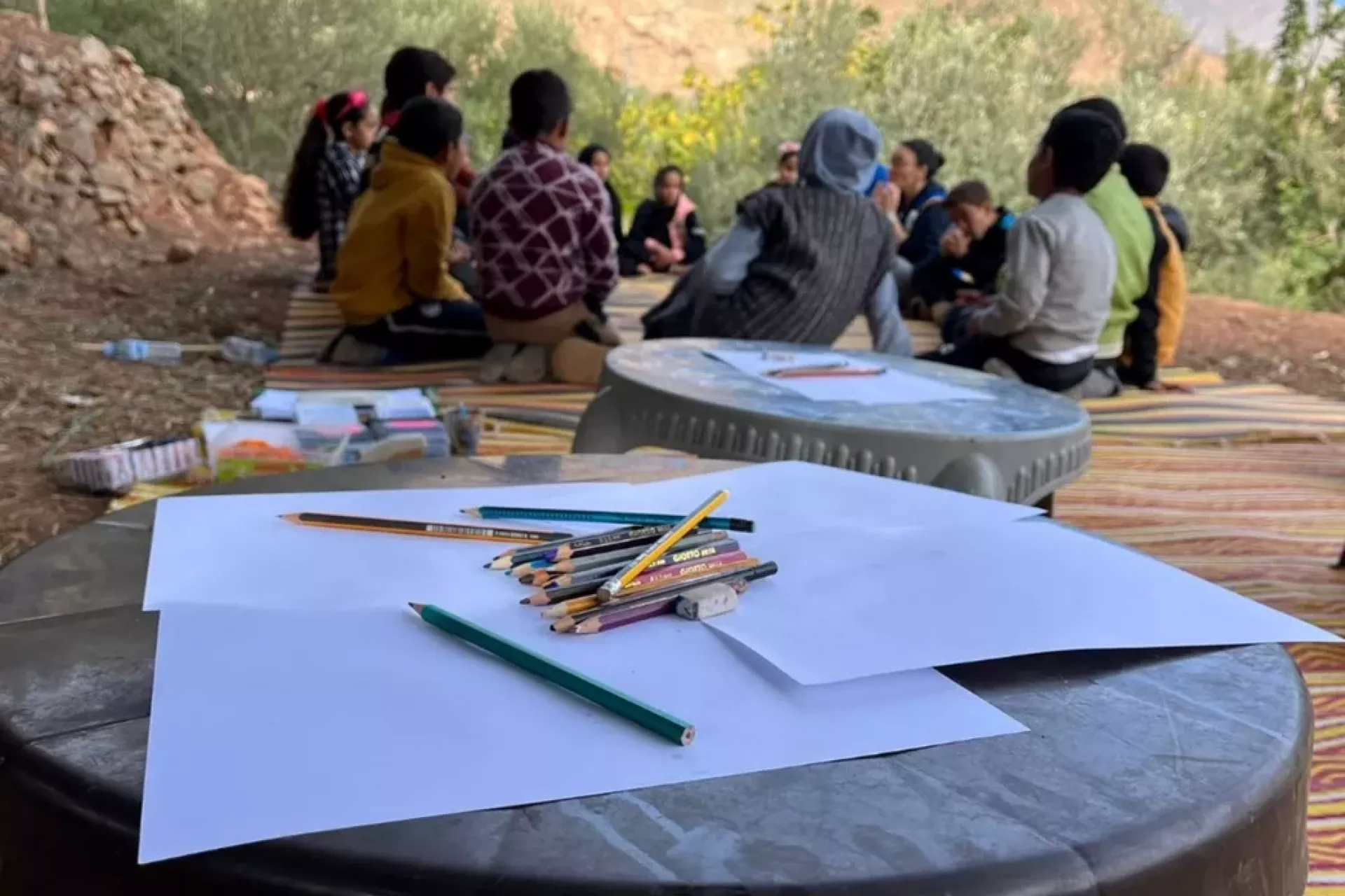 Un groupe d'enfants assis en cercle. 
