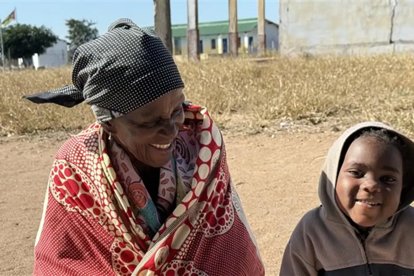 78-year-old Matilde Mujovo sits with her 3-year-old granddaughter, Dorlesa.