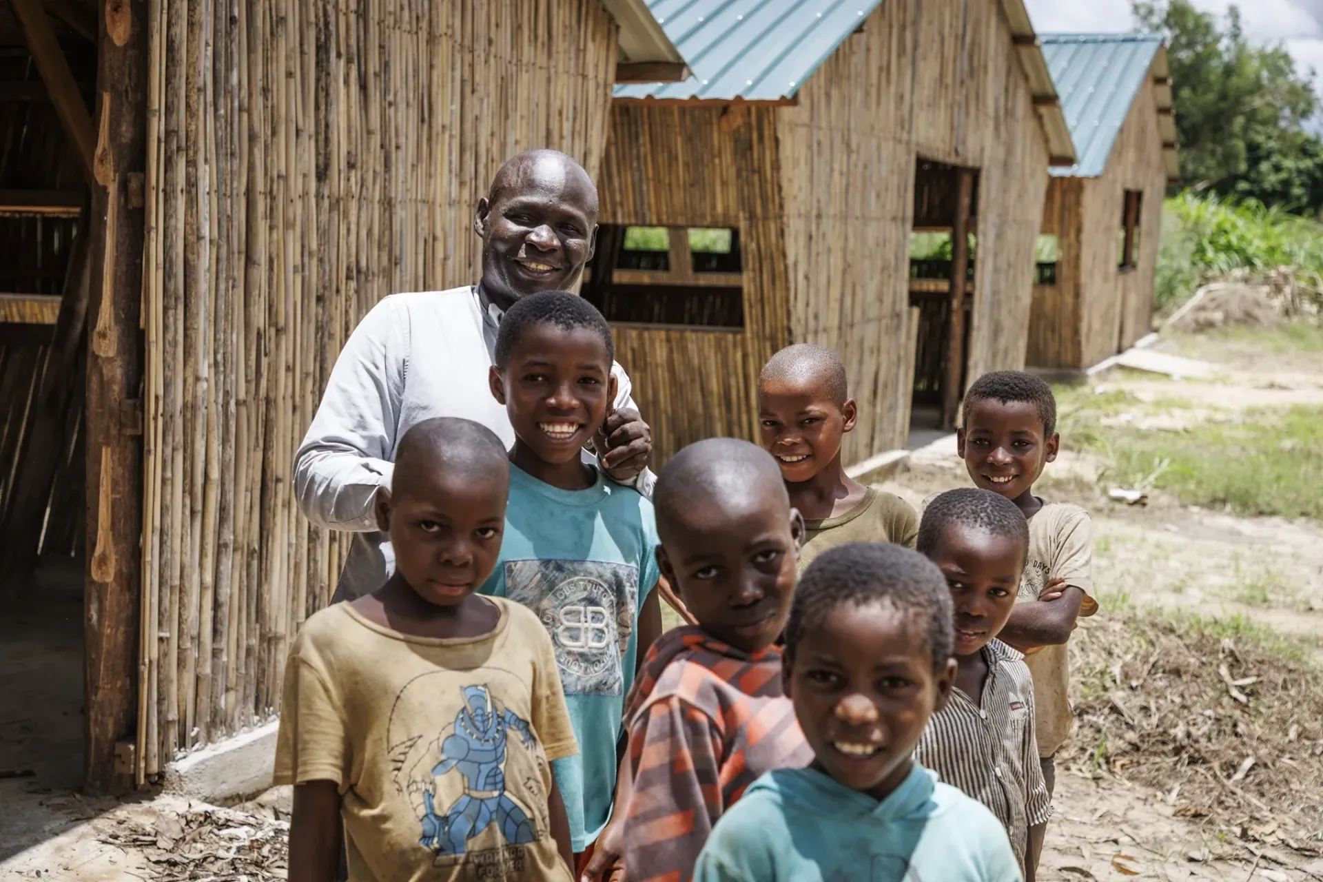 Martins Ambrosio, Murrupelane Basic School school&rsquo;s Deputy Director, surrounded by a group of school children.