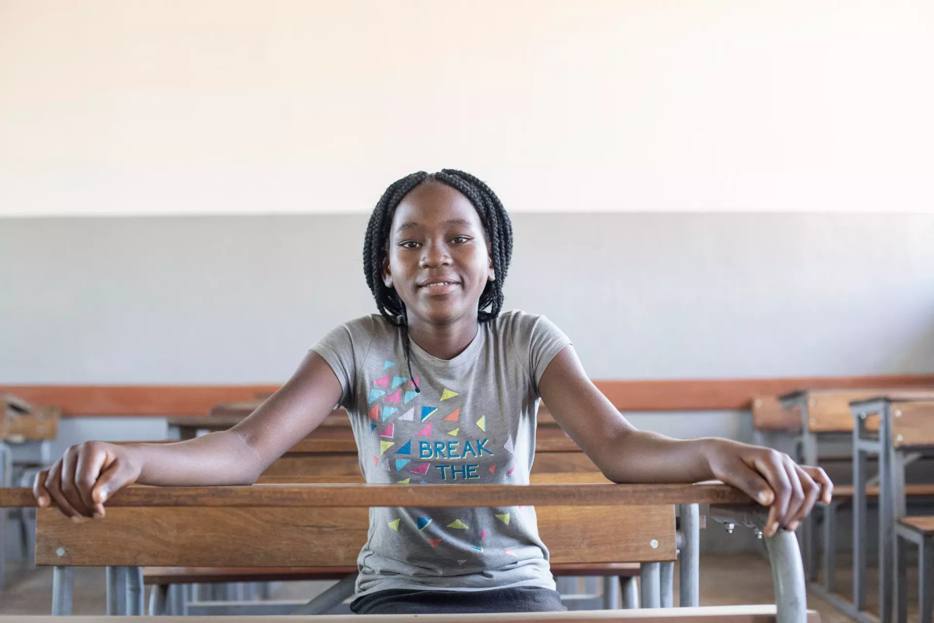 A girl seats inside her classroom in Mozambique.