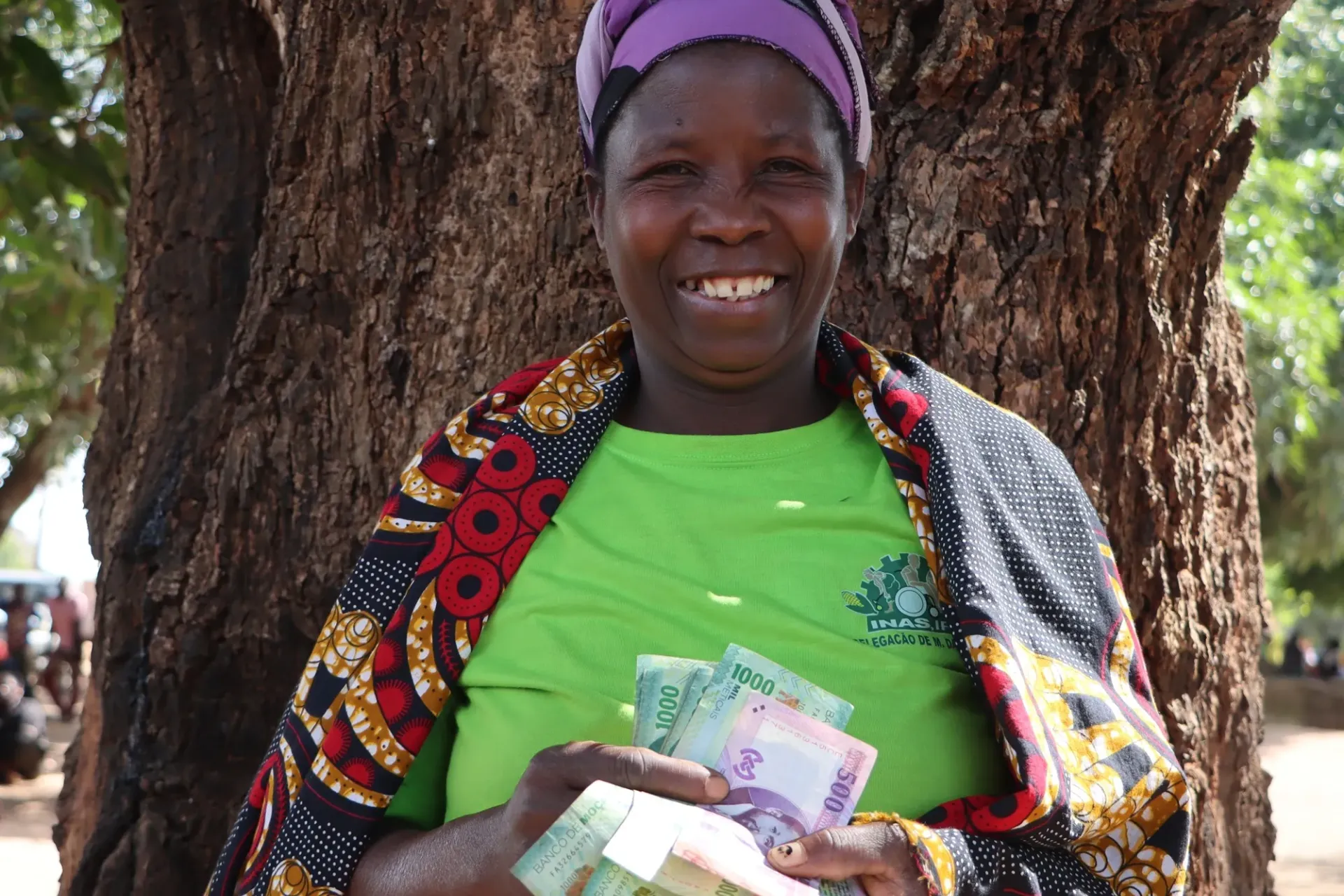 Joana Ambr&oacute;sio, 41, holding cash in her hands that was received through direct cash payments.