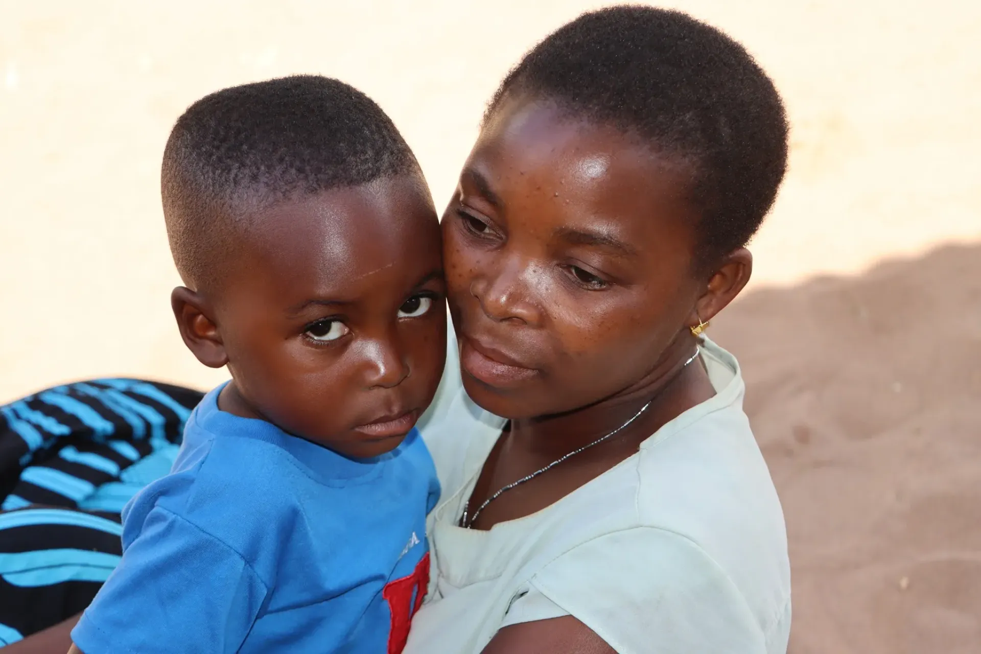 Zarina Hil&aacute;rio, 44, holding her baby boy in her arms in a rural community in Cabo Delgado province, Mozambique.