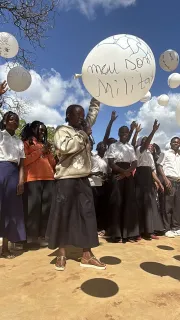 Students in Boila Namet&oacute;ria raise balloons inscribed with their dreams, affirming their right to education and freedom.
