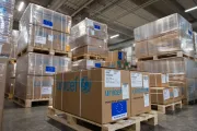 Stacks of UNICEF relief supplies are stored in a warehouse, prepared for distribution to children and families in need.