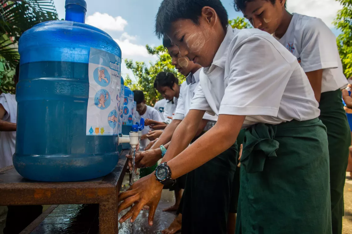 A group of children washing their hands at UNICEF washing station. 