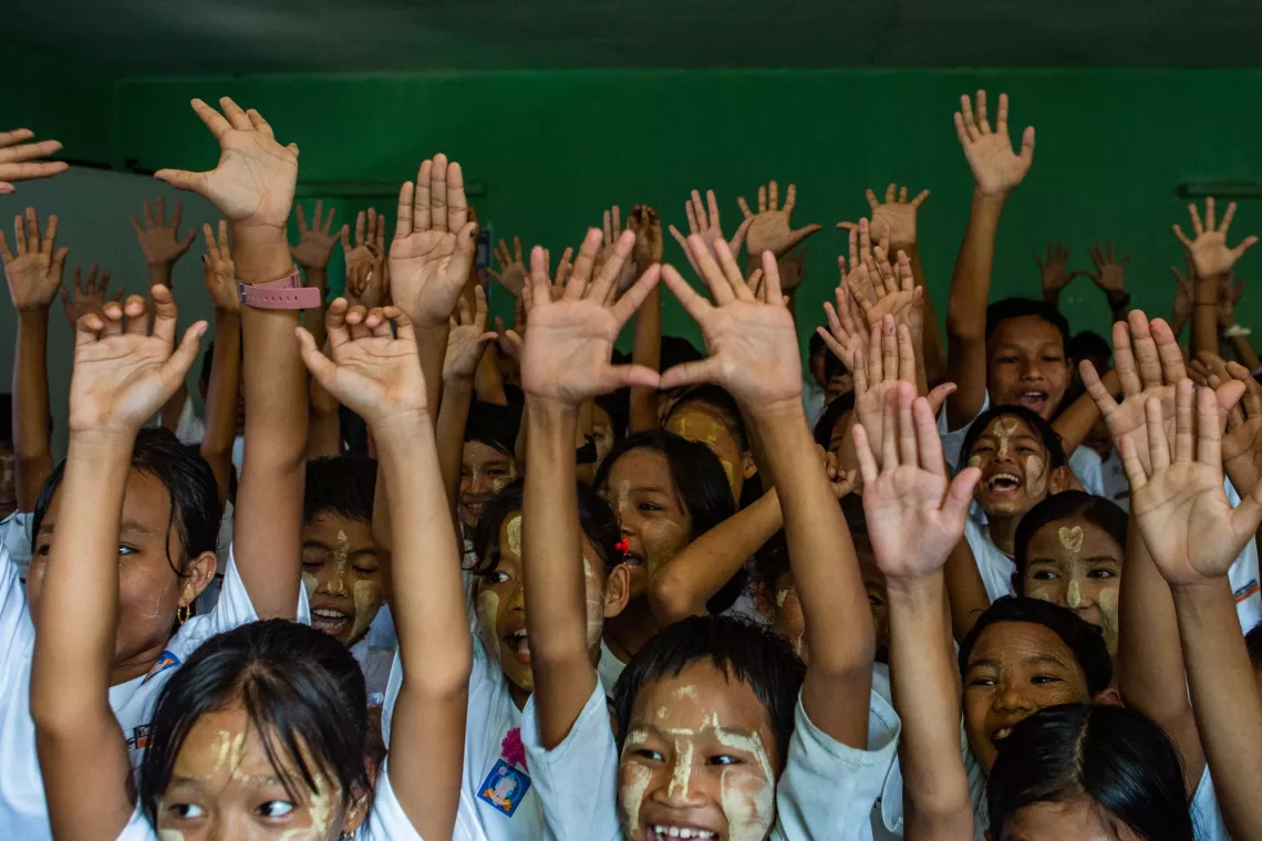 A group of children showing their hands after washing
