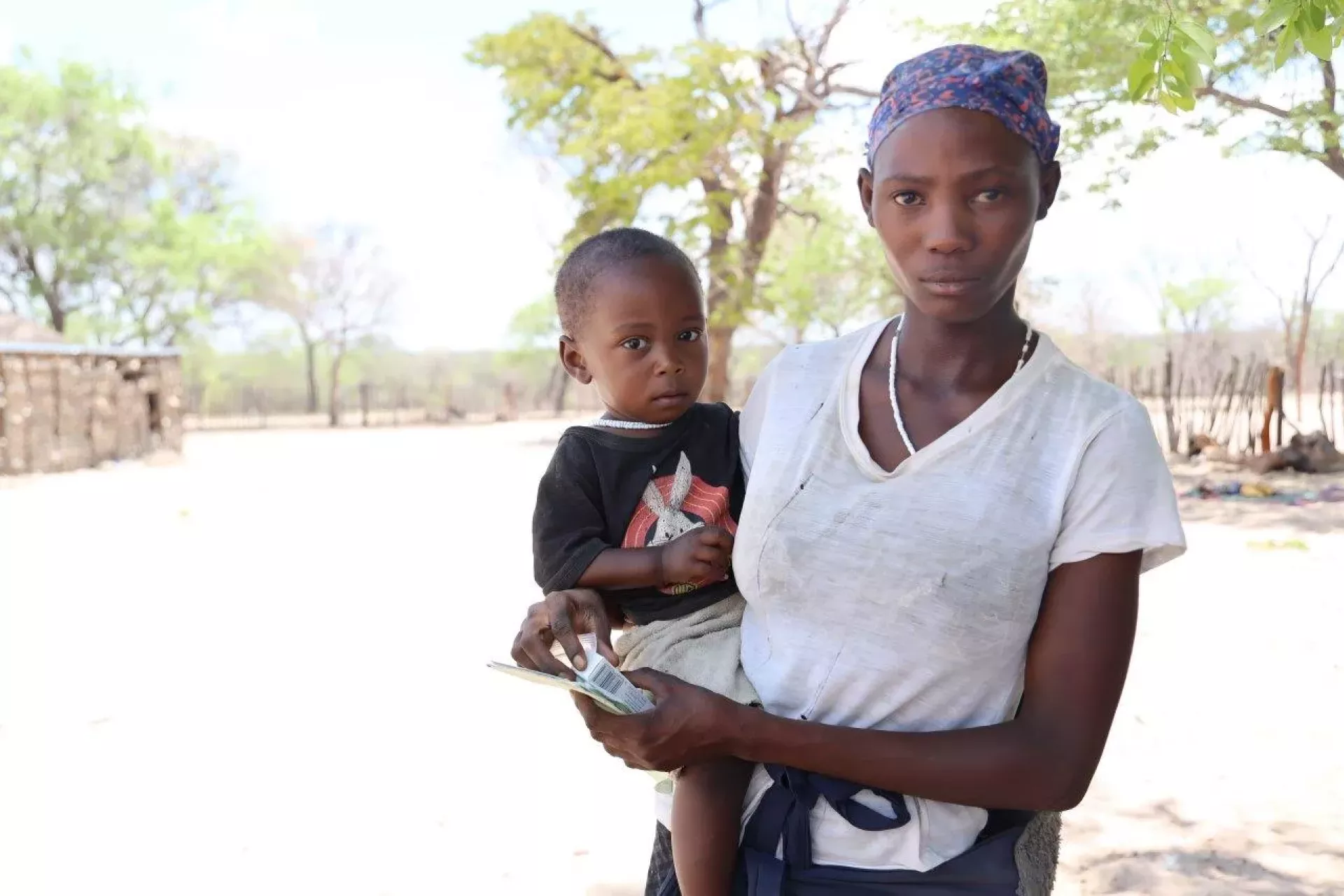 Mother carrying her one year old son on her hip