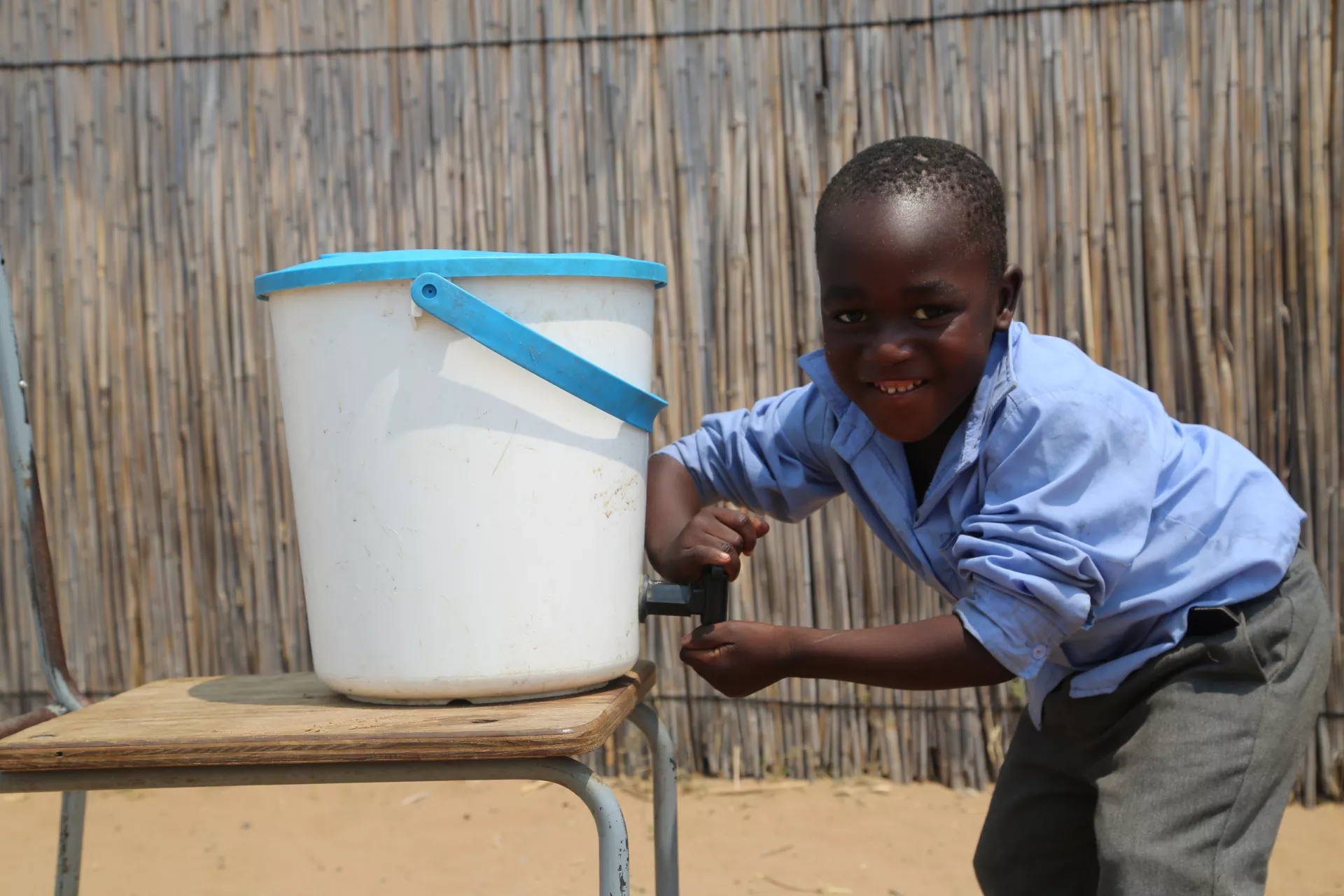 young boy washing hands