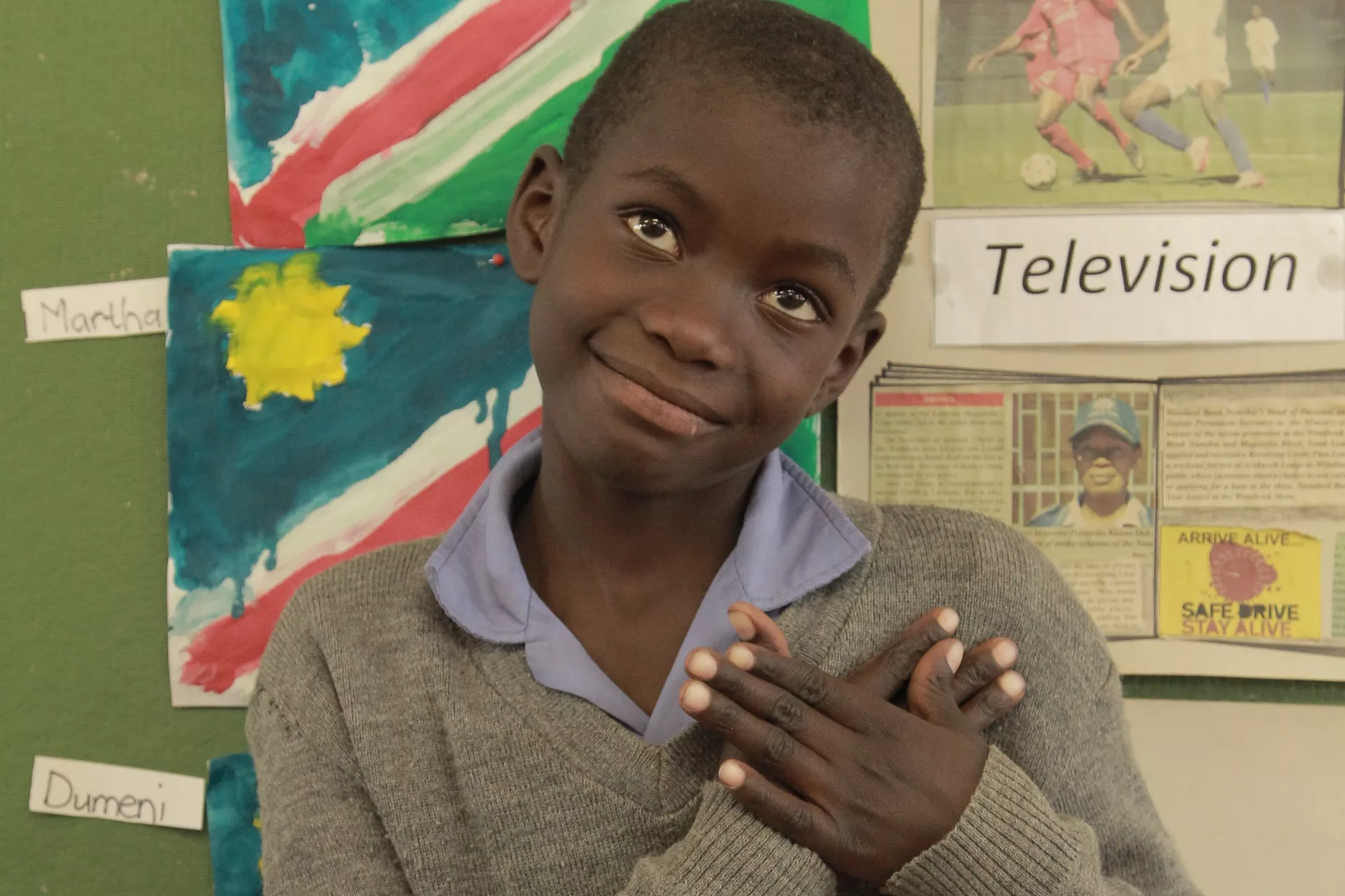 young hearing impaired boy using sign language to illustrate the word love