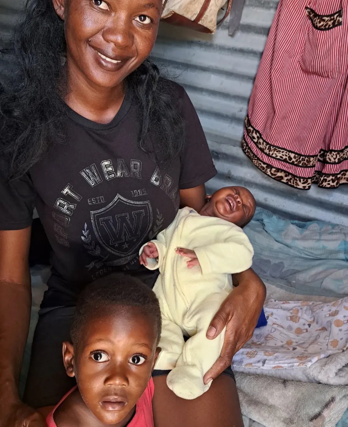 Mother sitting with her baby and toddler 