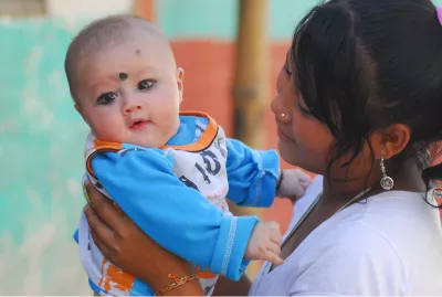 This image shows a child being held by the mother