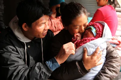 This image shows a couple with their newborn baby