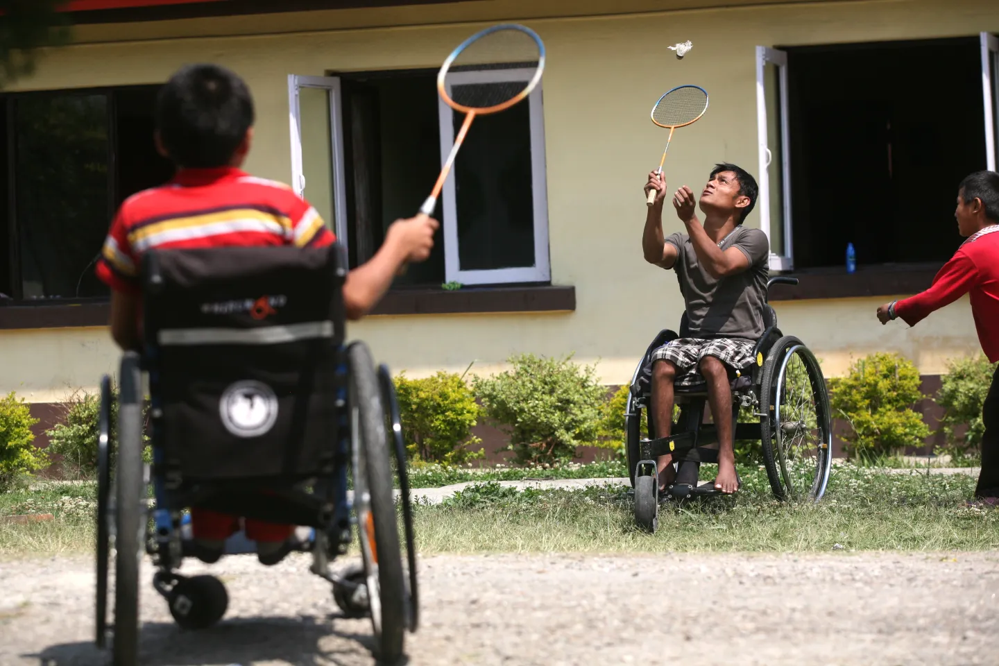 Young children playing Badminton with the help of Wheel Chair