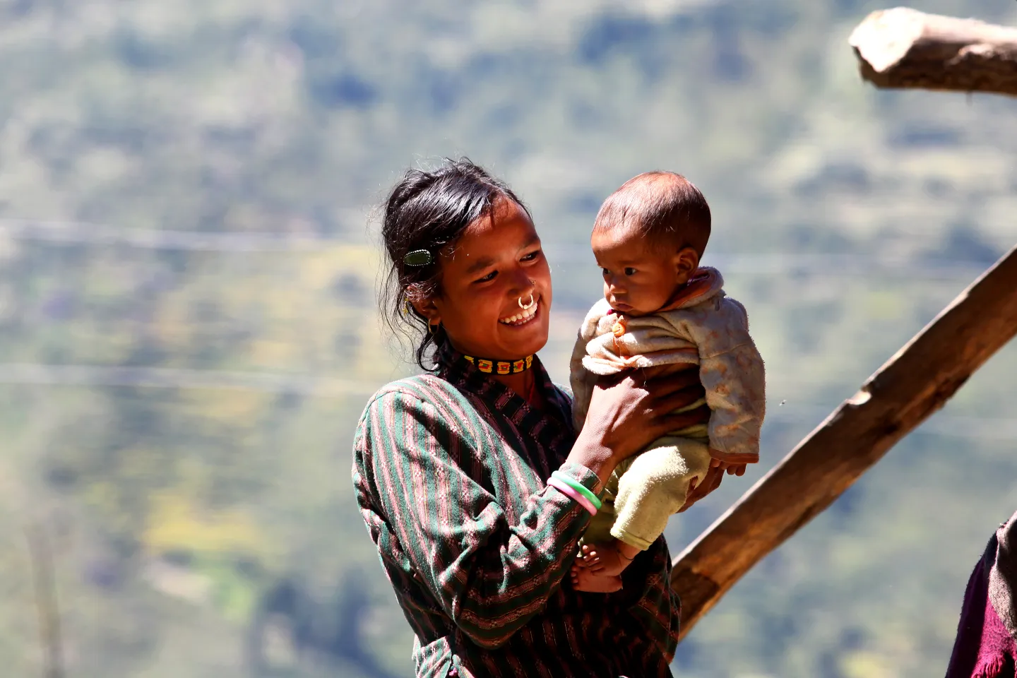 a mother carrying her child outdoors