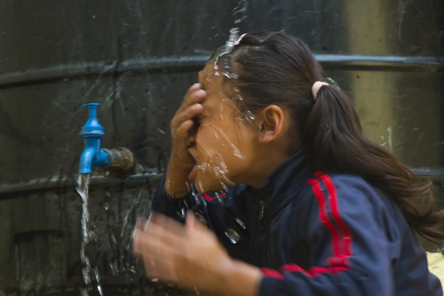 A child washing her face