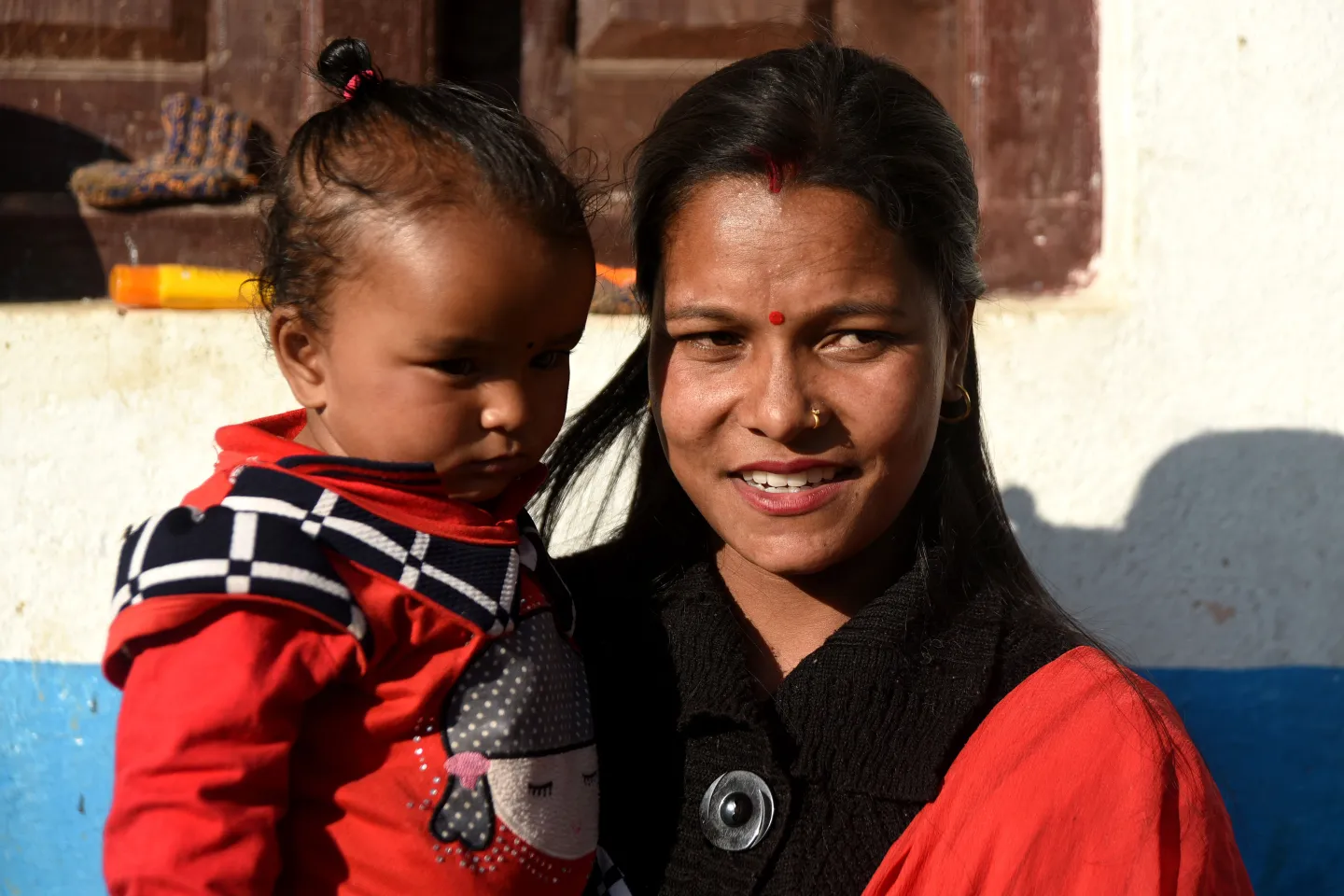 Kamala Nepali holds her son Sumit who was diagnosed as being severely malnourished.
