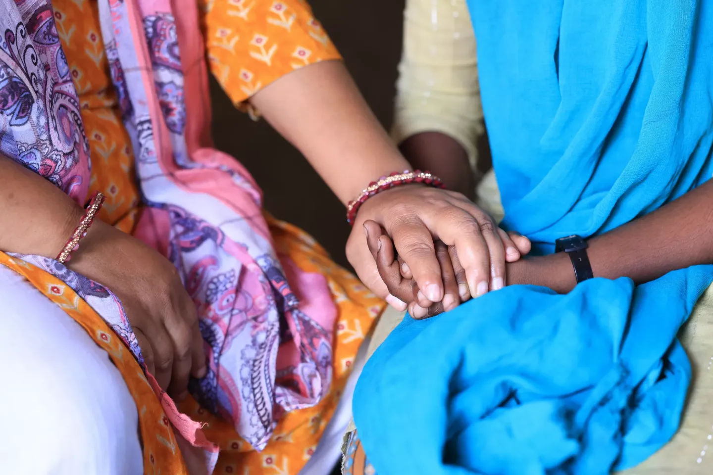 a person holding another person's hands supportively