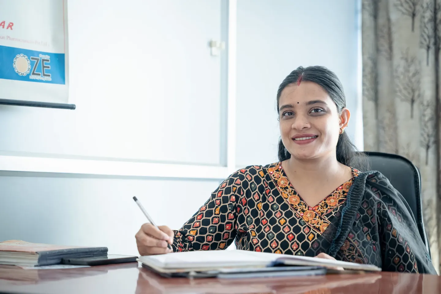 A portrait image of Aakriti Giri in her office  