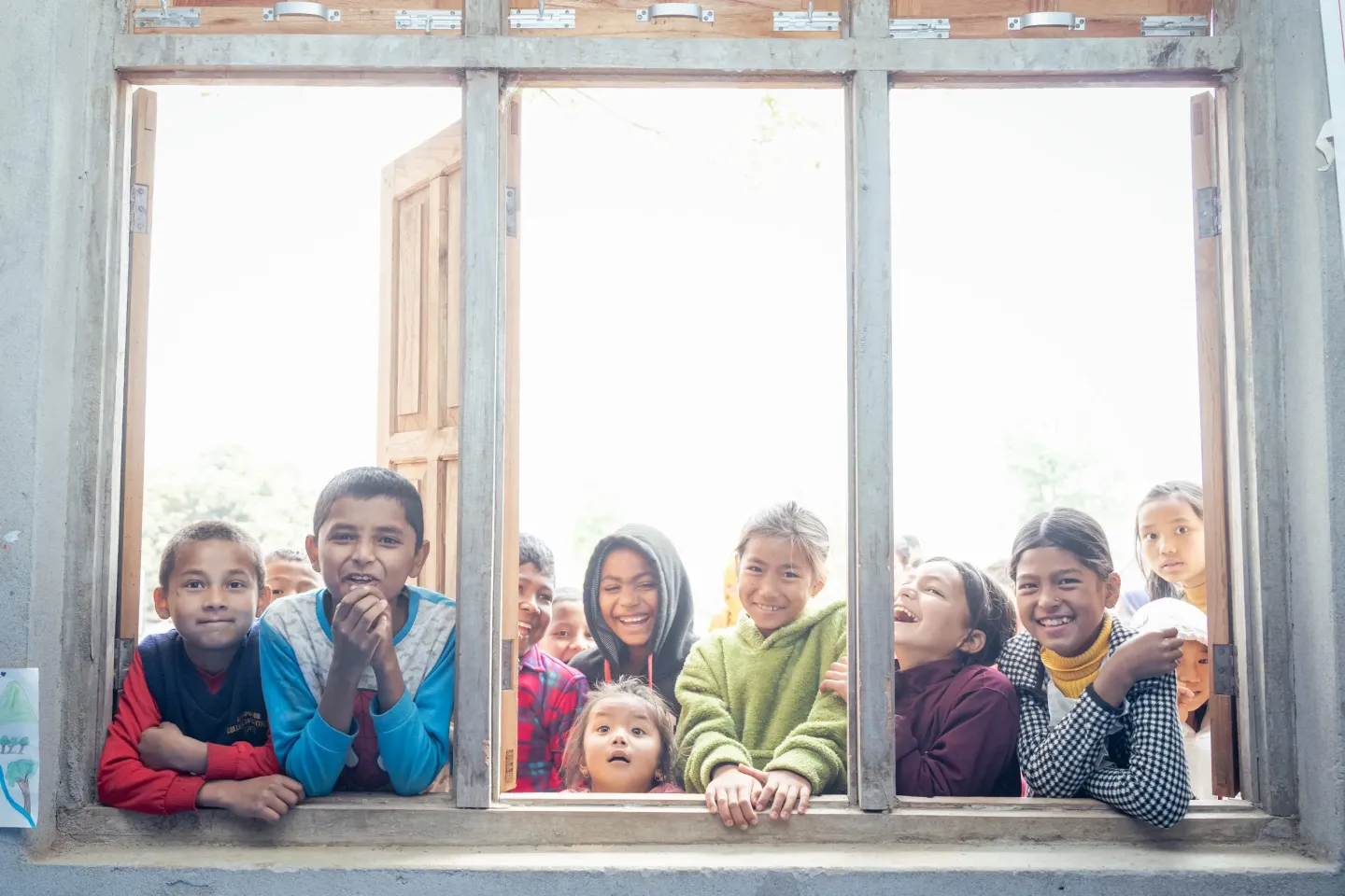 Group of children posing infront of the window