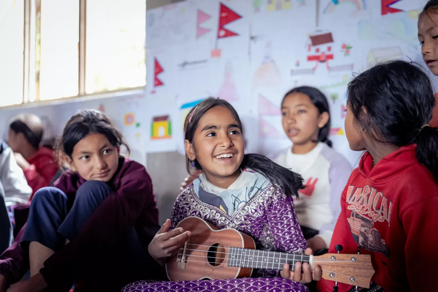 Radhika playing a guitar with her friends