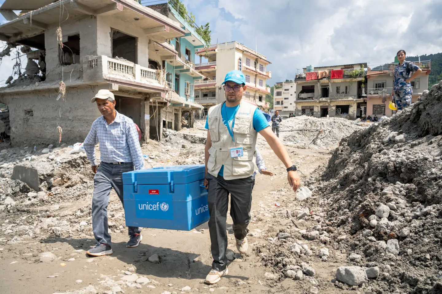 On 12 September 2026, Hem Raj Joshi, Cold Chain Specialist for UNICEF Nepal, and government staff help transport Oral Cholera Vaccine (OCV) doses from the Bidur Municipality office in Nuwakot, Nepal