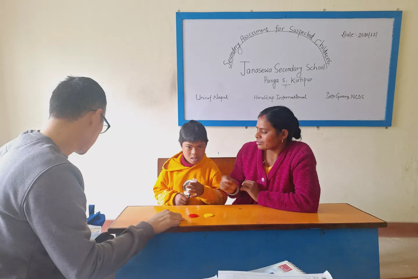 A small child with disability and his mother at school