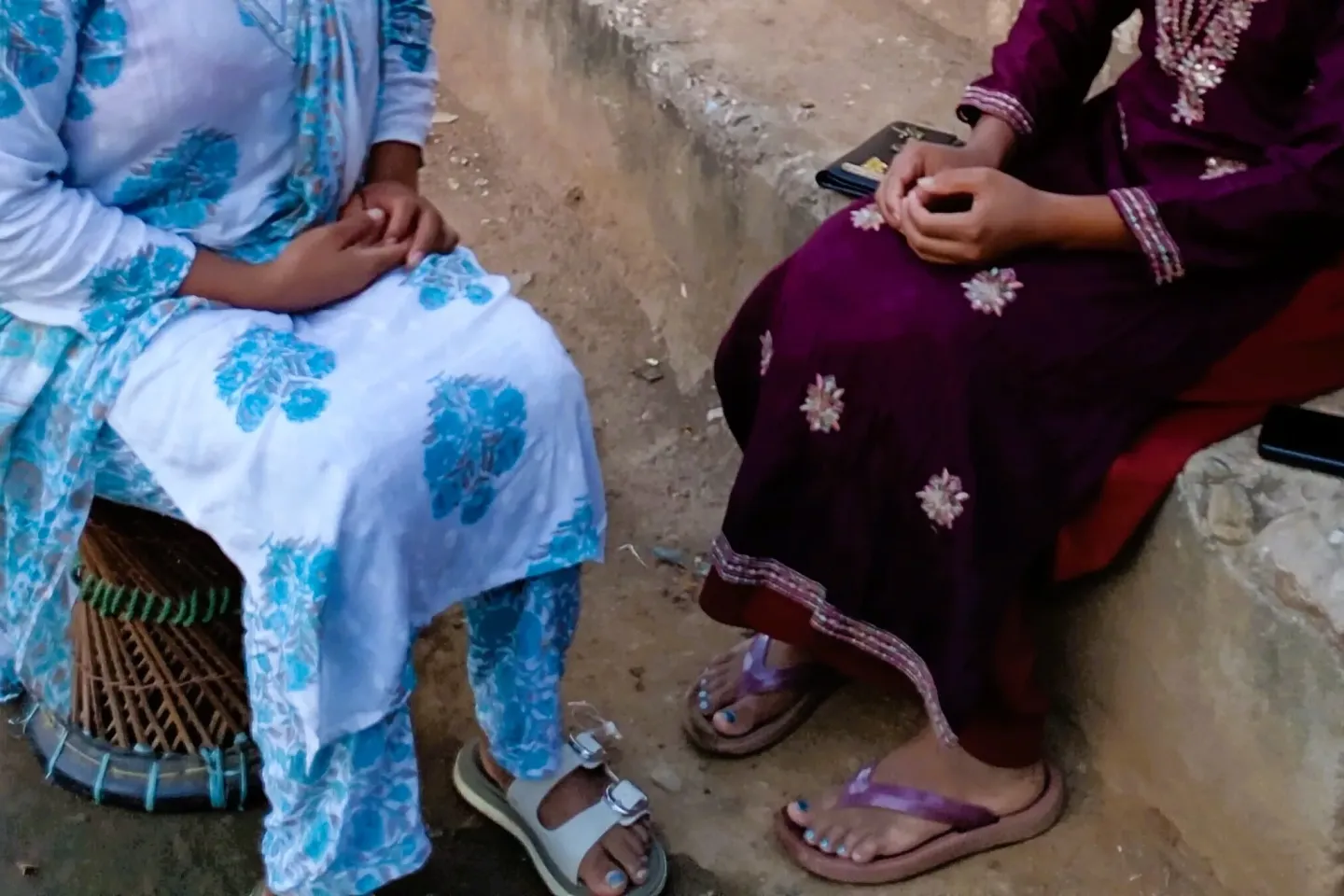 two women sitting across from each other