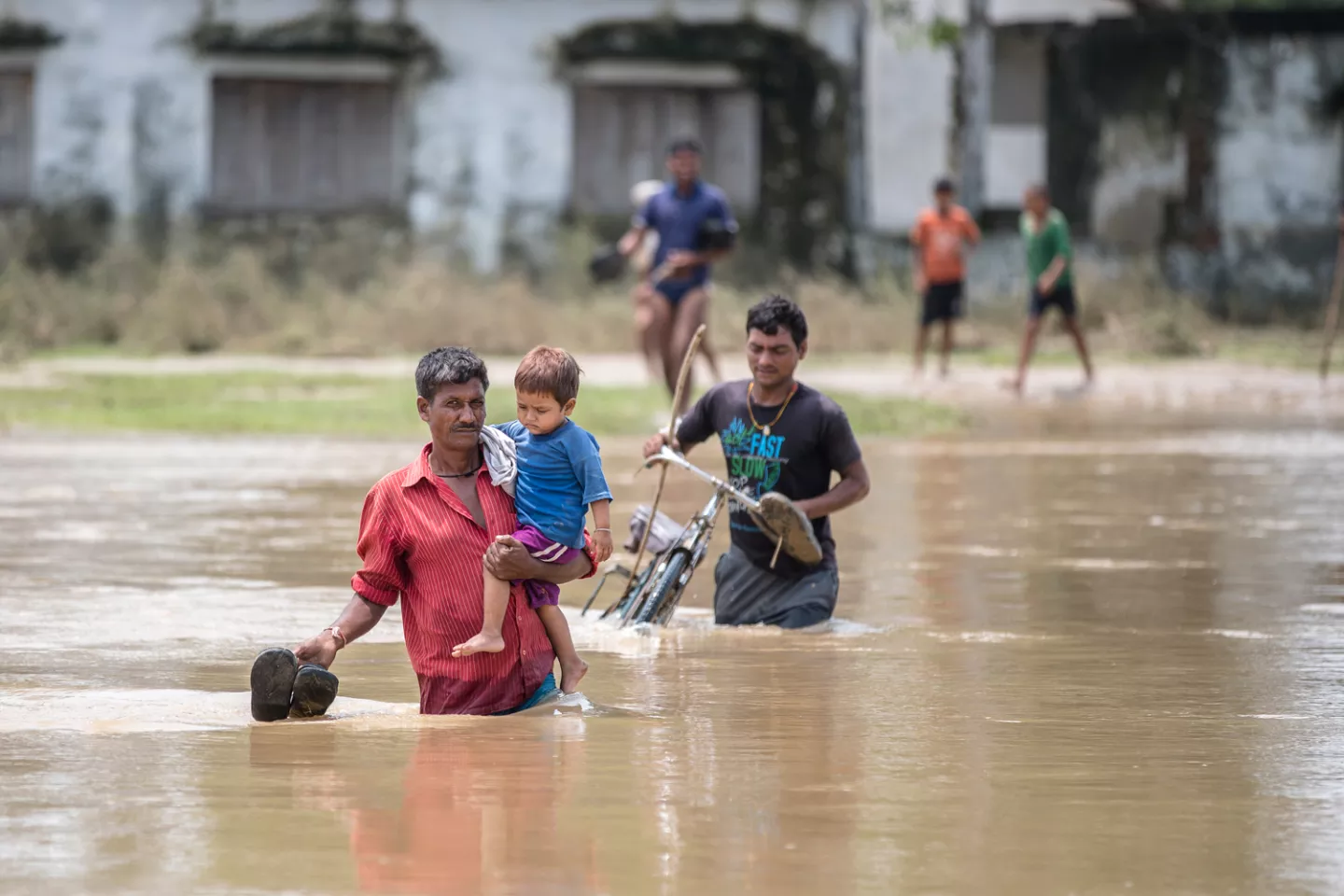 People crossing flooded area