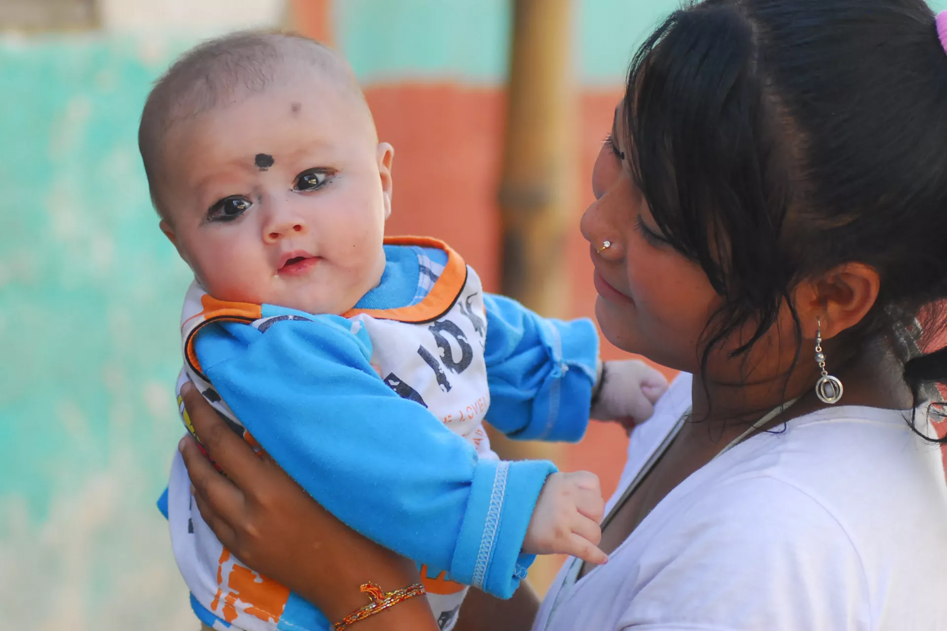 This image shows a child being held by the mother