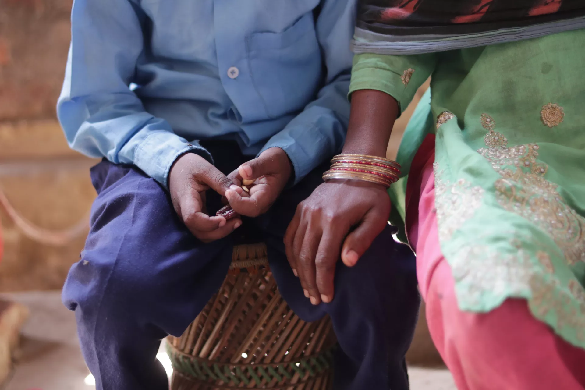 a mother putting her hand on her son's lap to comfort him