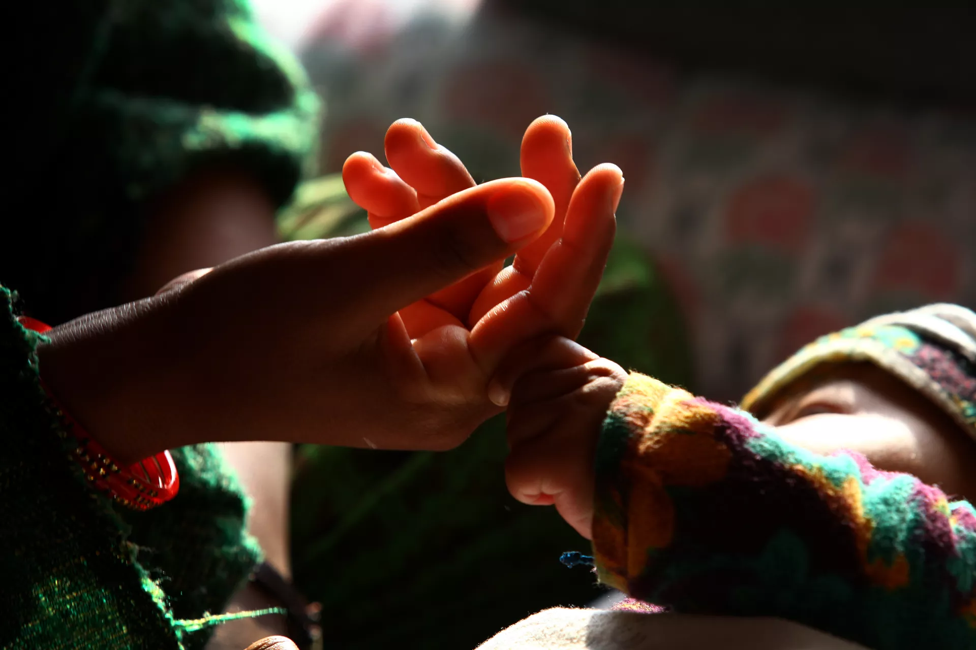 visual of a mother's hand holding a child's