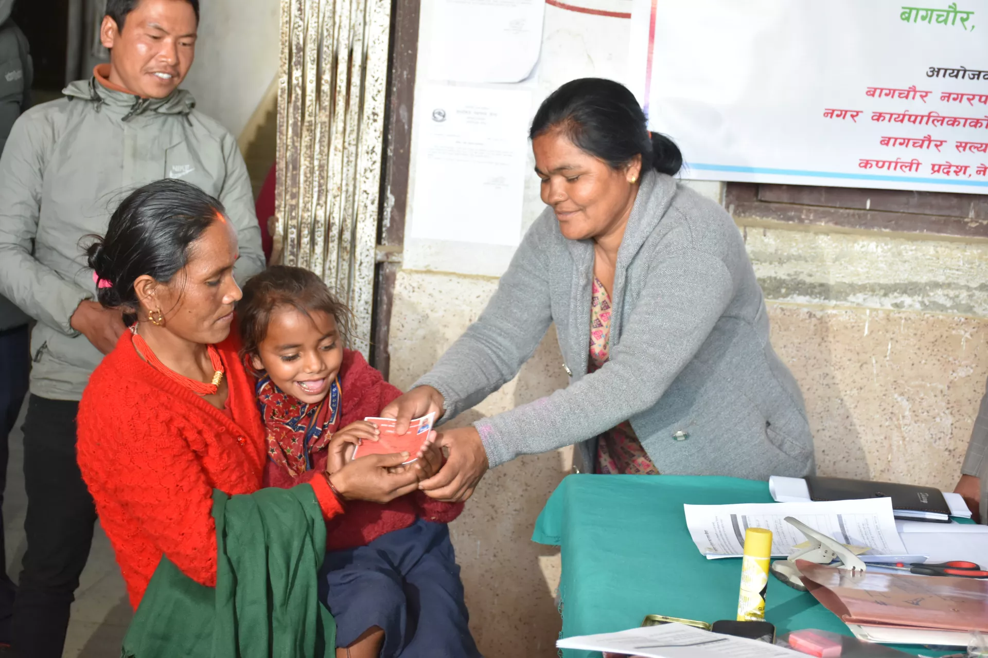 A smiling Karishma receives her disability ID card following a medical check up at the screening camp. 