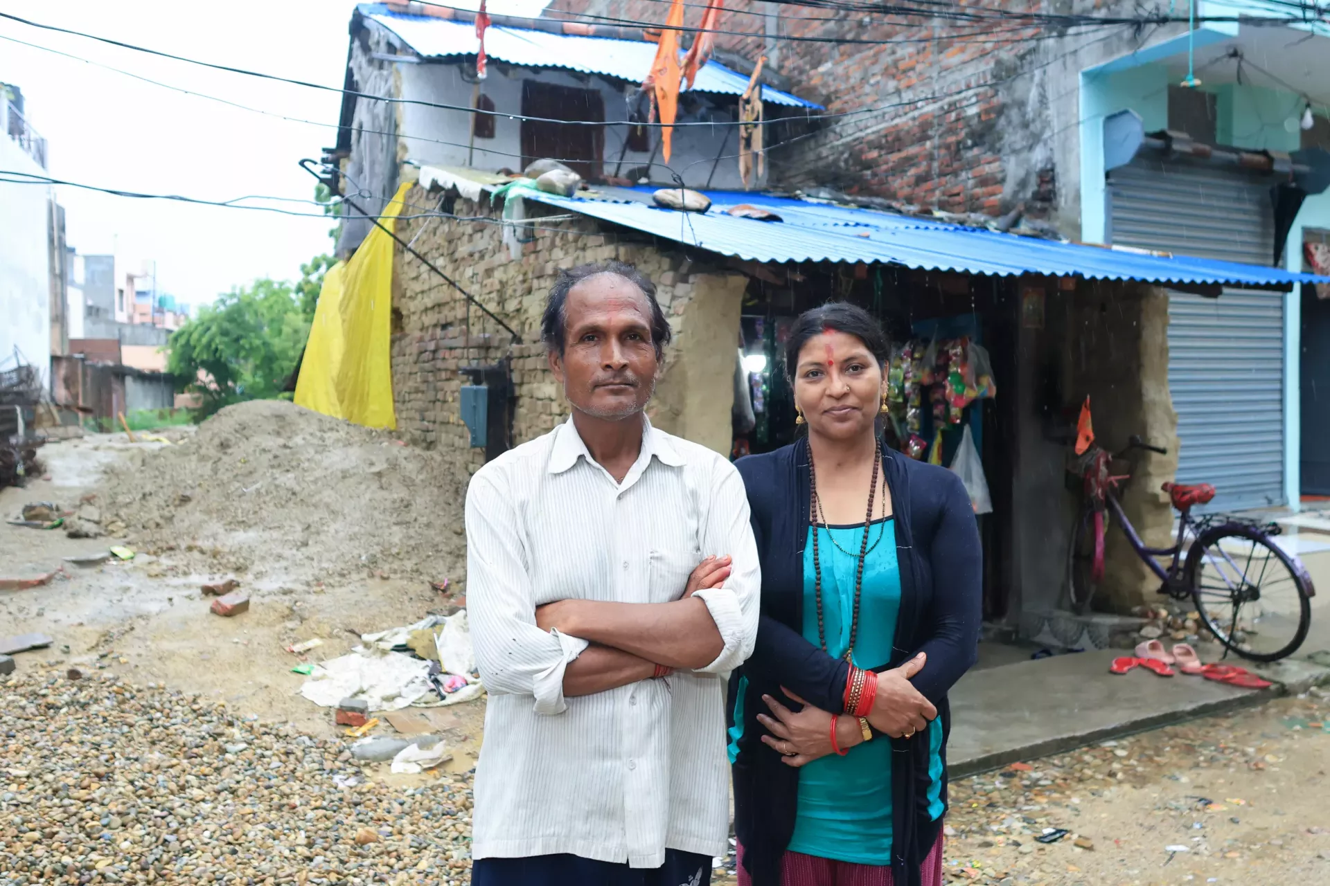 Uttam and Lila outside their home