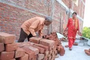 Lila and Uttam collecting bricks in one place