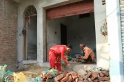 Lila and Uttam collecting bricks inside their house for construction