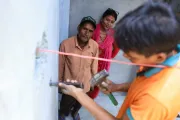 Lila and Uttam observing the house construction work