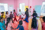 Group of SAGE participants holding hand in walking in circle