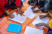 A closeup picture of SAGE participants drawing on a paper