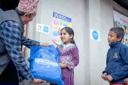 Radhika receiving learning supplies