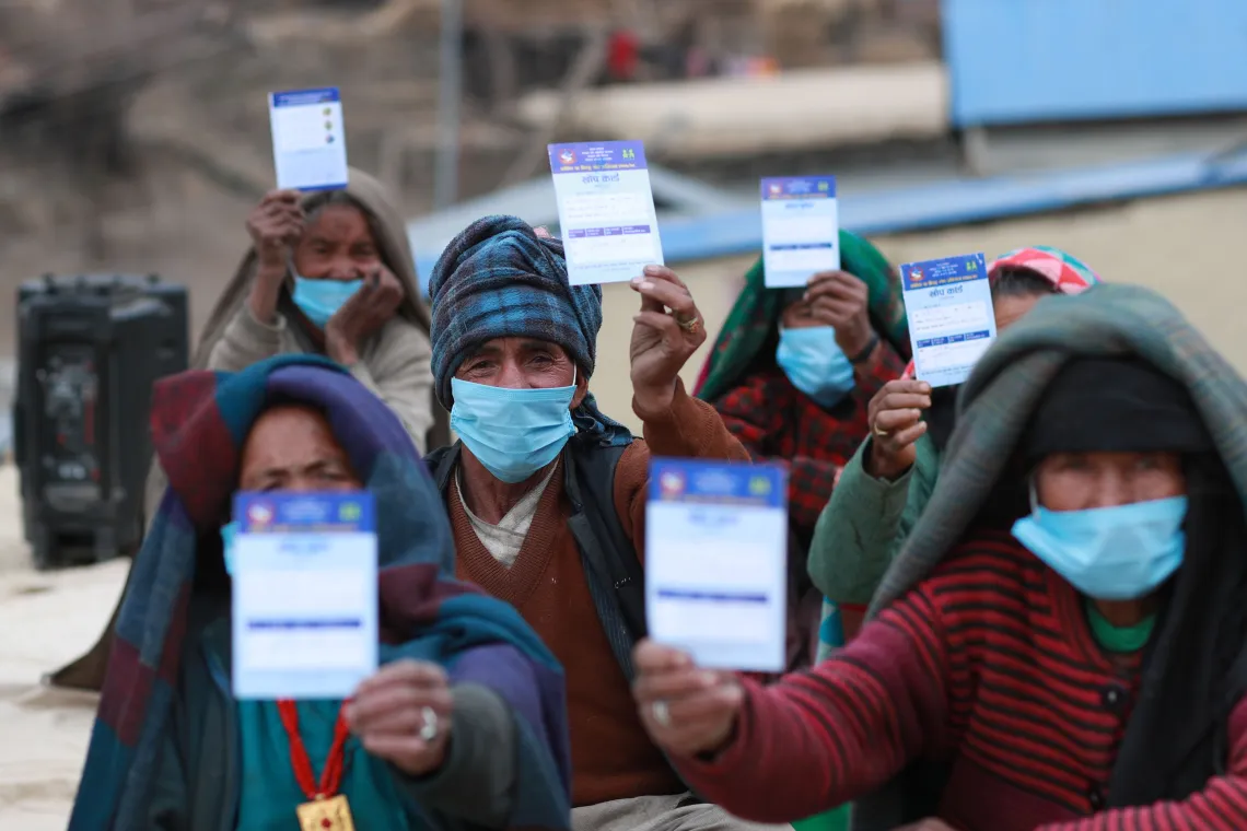 This image shows elderly people at the COVID-19 vaccination site in Jumla