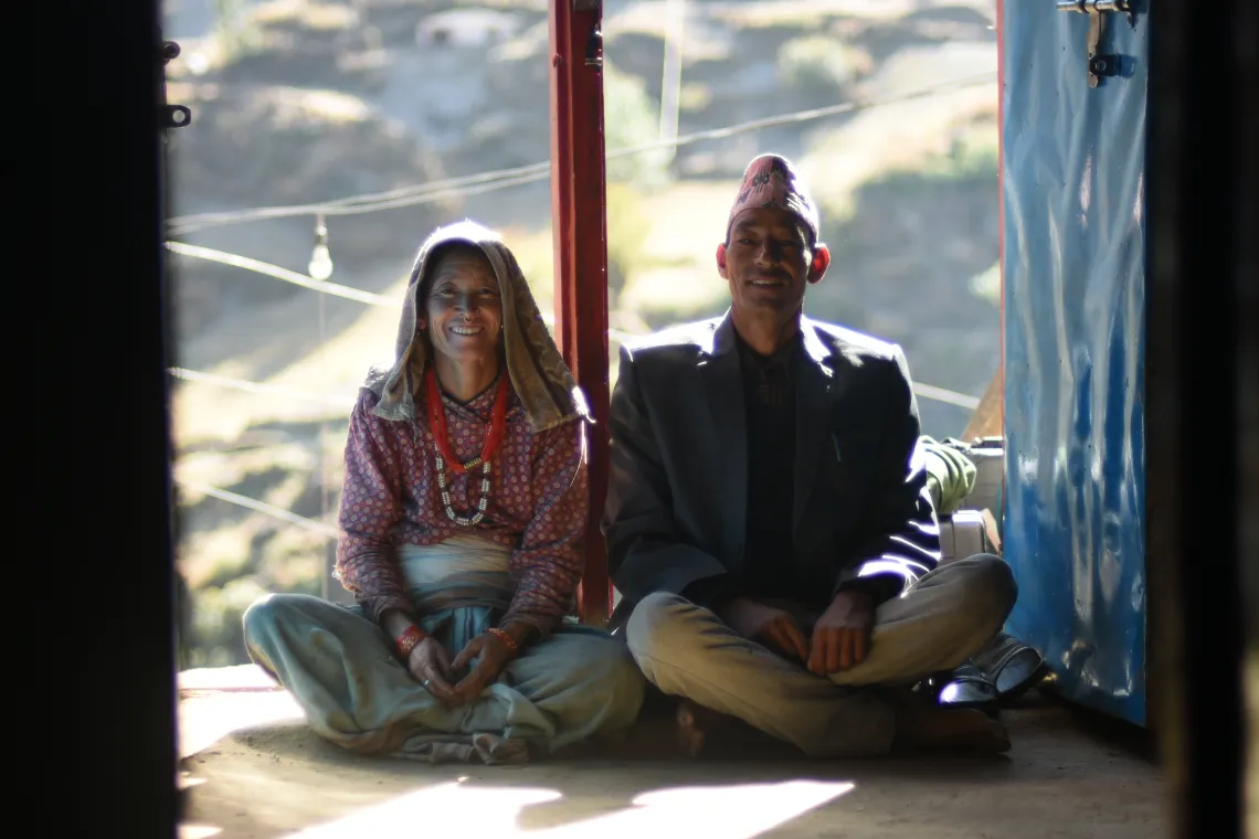Dharmi Bhandari (left) sits next to husband Jhim Bahadur (right) in their home in Bham Bada, Mugu District. According to Dharmi, Jhim has been a great support to her in taking care of the house and the family.