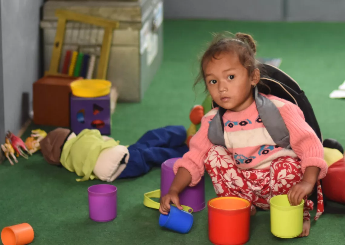 This image shows a young child in her ECD classroom