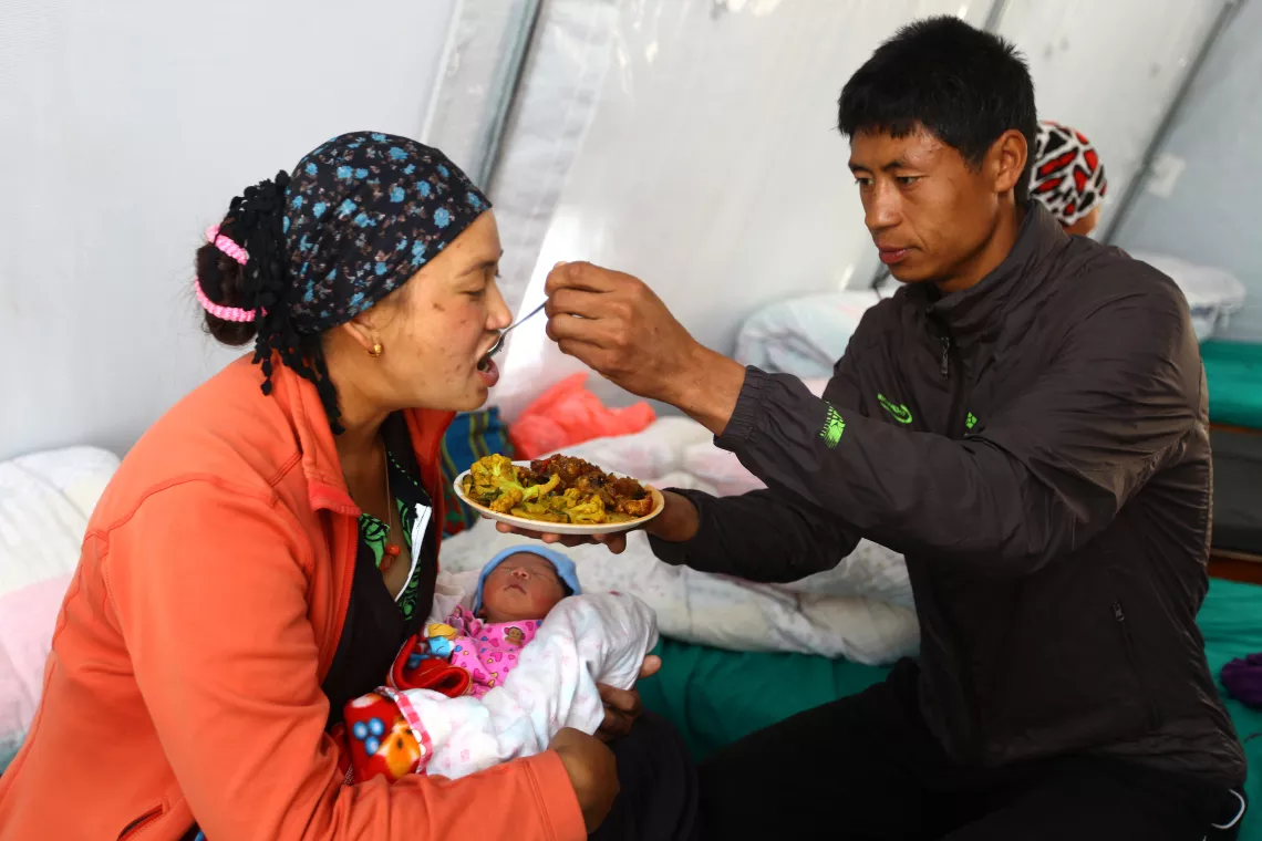 a husband feeds his wife