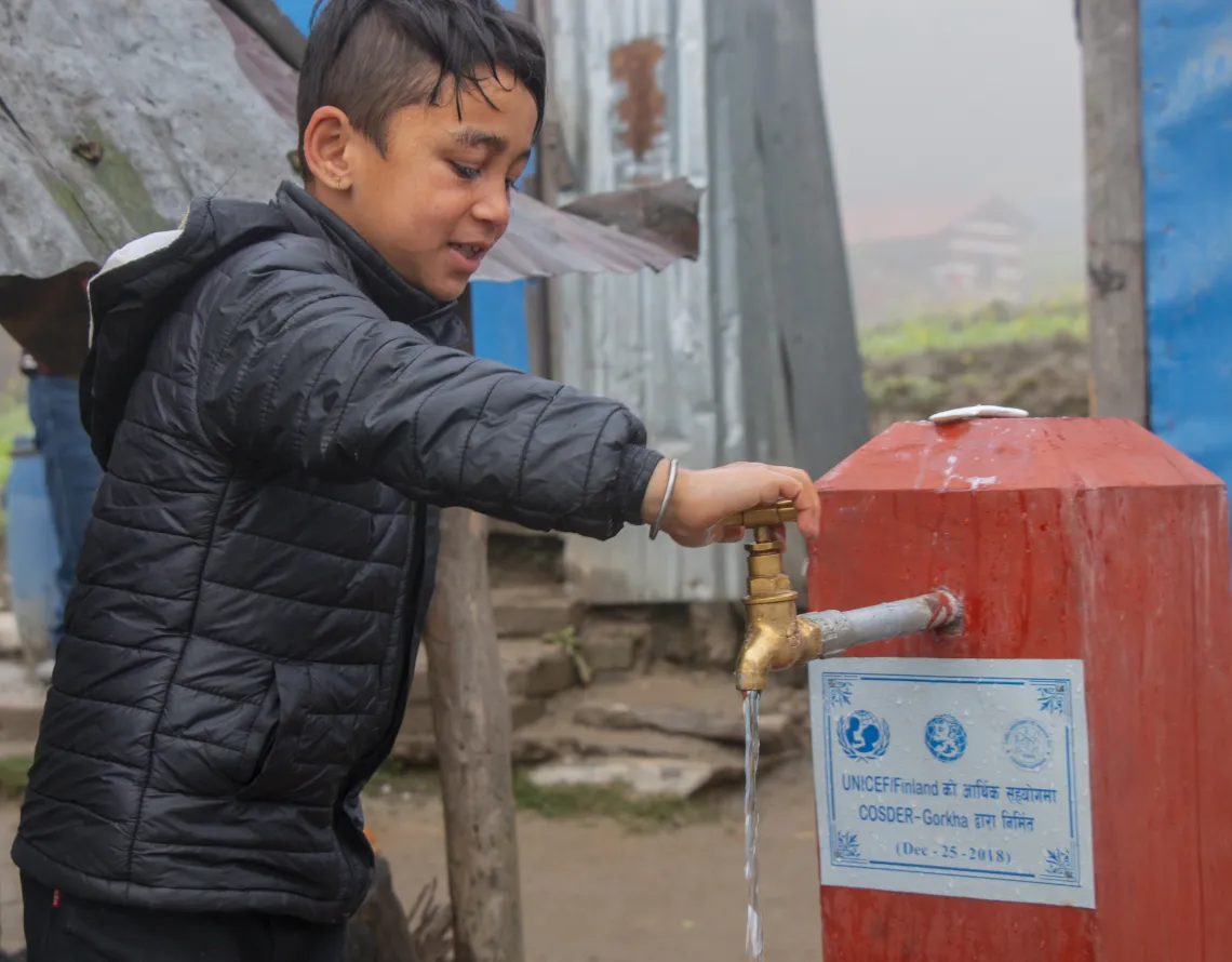 Boy using water tap 